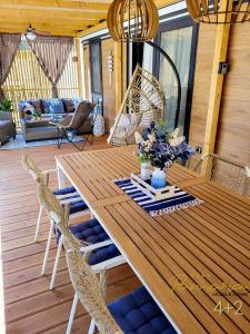 a wooden table and chairs on a deck at PAMARA Mobile Home in Biograd na Moru