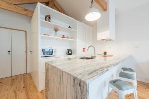 a kitchen with a large marble counter and a chair at GuestReady - Chic city nest in Porto in Porto
