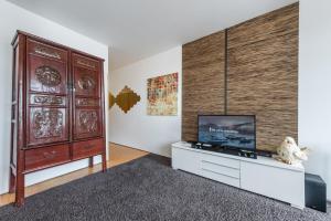 a living room with a tv and a large wooden wall at GuestReady - Modern stay near Douro River in Porto