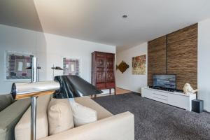 a living room with a couch and a television at GuestReady - Modern stay near Douro River in Porto