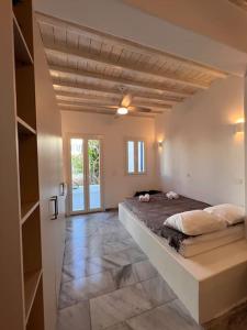 a bedroom with a large bed in a room at “Myrto” Apartments- Ornos Beach in Mýkonos City