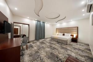 a hotel room with a bed and a flat screen tv at فندق مشارف ابها in Abha