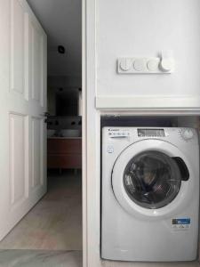 a white washer and dryer in a white room at “Myrto” Apartments- Ornos Beach in Mýkonos City