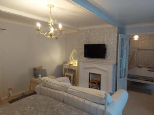 a living room with a couch and a fireplace at The family room at the bungalow in Willesborough