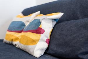 a pair of colorful pillows sitting on a couch at GuestReady - Urban escape with a view in Porto