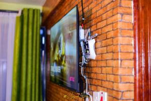 a wall with a video game system on a brick wall at Upper Haven Apartment in Kakamega