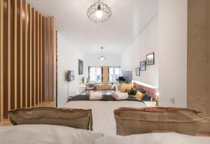 een slaapkamer met een groot bed en een woonkamer bij GuestReady - Trendy city central studio in Porto