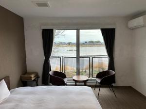 Postel nebo postele na pokoji v ubytování 里沼リゾート　Hotel KOMORINU