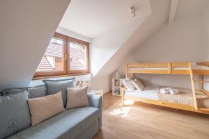 a living room with a couch and a bunk bed at Flatbook Apartamenty - Mikoszewo Dom Amber Cottage in Mikoszewo