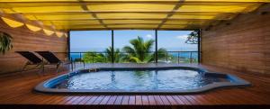 a large swimming pool in a room with a large window at Luxury 4 pool Seaview 6 bedroom Villa on Surin Hill in Surin Beach