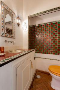 a bathroom with a toilet and a sink and a mirror at Casa da Moura in Lagos