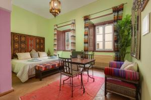 a bedroom with a bed and a table and chairs at Casa da Moura in Lagos