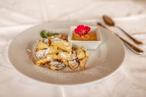 a white plate of food on a table at Gasthof Hirschen in Sibratsgfäll