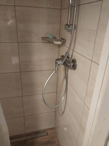 a shower with a hose in a bathroom at Na Rogu in Lębork