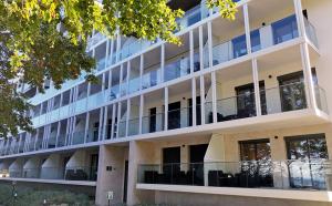 an external view of a building with large windows at Apartamenty WRZOS w Perłowej Przystani in Sianozety +4 photos