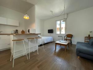 a kitchen and living room with a bed and a table at Grand Studio centre ville, gare et plage à pied in Pornichet