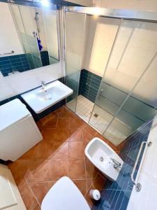 a bathroom with a sink and a toilet and a shower at Villa Claudia piscina privata in Stintino