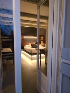 een slaapkamer met een bed door een deur bij Trulli Terra Magica in Putignano