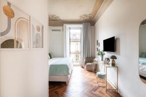 a bedroom with a bed and a living room at Easylife - Suite in Porta Venezia in Milan