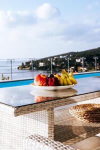 a plate of fruit on a table on a balcony at Luxury Apartments La Villa in Chorto