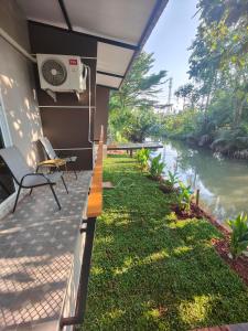 a patio with a view of a river at ริมธารริเวอร์เพลส in Surat Thani