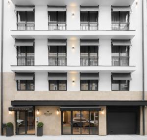 an exterior view of a white building with windows at Hotel Collect & Residence in Budapest