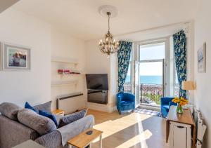 a living room with a view of the ocean at Coastal Nest - Hythe in Hythe