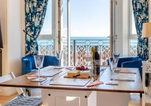 a dining room table with a view of the ocean at Coastal Nest - Hythe in Hythe