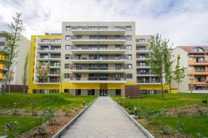 a large apartment building with a walkway in front of it at WestSide Garden Apartments by FirstHost in Budapest