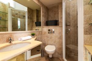 een badkamer met een wastafel, een toilet en een douche bij Frères Pradignac in Cannes