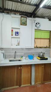 a kitchen with white cabinets and a sink at seaview hostel in George Town