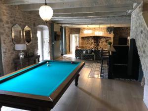 a pool table in a living room with at Domaine des Annouillards in Sornac