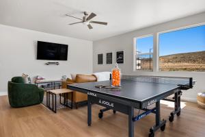 a living room with a ping pong table in it at Paddle and Play townhouse in St. George