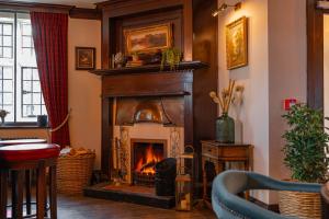 a living room with a fireplace in a room at Stone House Hotel in Hawes