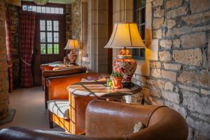 a room with chairs and a table with a lamp on it at Stone House Hotel in Hawes +48 photos