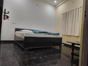 a bedroom with a bed and a table in it at Sky Inn paying guest house in Varanasi