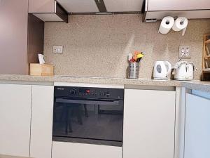 uma cozinha com uma bancada com um fogão em Emotion-고층뷰, 3룸, 화2 신축, 건조기, 세탁기, 이마트2분, 별내역3분, 출장 및 장기숙박 추천 em Namyangju mais 32 fotografias