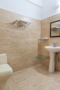 a bathroom with a toilet and a sink at Mountain Crest Kasauli I 2 Bhk Service Apartment I Kasauli in Kasauli