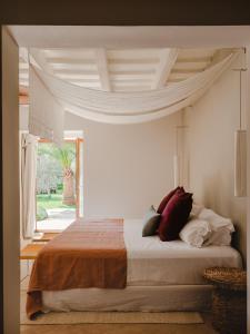 a bedroom with a bed with pillows on it at Amagatay Menorca in Alaior