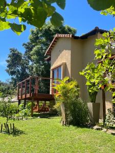 a house with a deck in the yard at Jade Mountain Cottage 玉山小屋 in White River