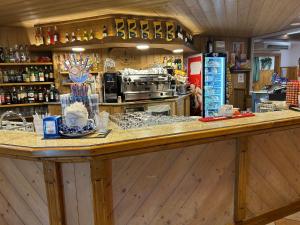 a kitchen with a counter in a store at Bella Italia & EFA Village in Forni Avoltri