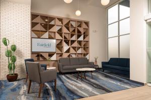 a waiting room with two couches and a tv at Fairfield by Marriott Inn & Suites San Luis Potosi in San Luis Potosí