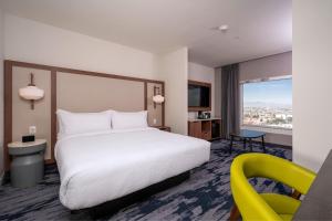a hotel room with a bed and a yellow chair at Fairfield by Marriott Inn & Suites San Luis Potosi in San Luis Potosí +20 photos