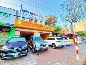 a group of cars parked in front of a store at Quoc Dung Hotel in Rạch Giá