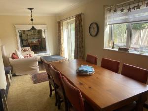 a dining room with a wooden table and chairs at Stunning 2 bed 2 bath house in Carleton in Pontefract