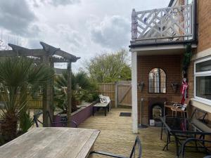 a patio with a table and chairs and a building at Stunning 2 bed 2 bath house in Carleton in Pontefract