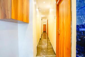 a corridor with a long hallway with a long hallway at FabExpress Emirates Suits in Mumbai