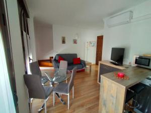 sala de estar con mesa y sillas y cocina en Casa / Apartamento Azahar, en Ronda