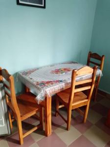 a table with two chairs and a table with a quilt on it at CHEZ COLOMBE in Abomey-Calavi +8 photos