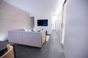 a living room with a couch and a tv at Ampersand - Bright 2-Bedroom Apartment in Barcelona